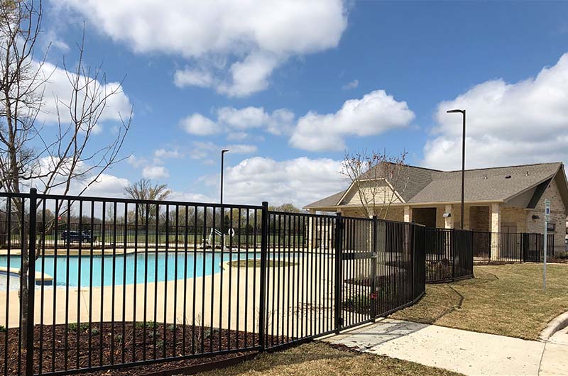 Pool and building with metal fence