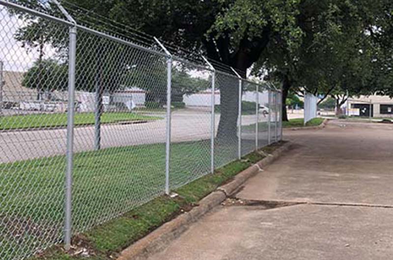 Commercial chain link with parking lot and tree