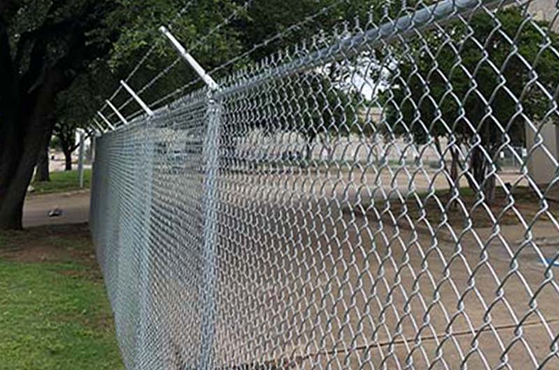 Commercial chain link with parking lot and trees