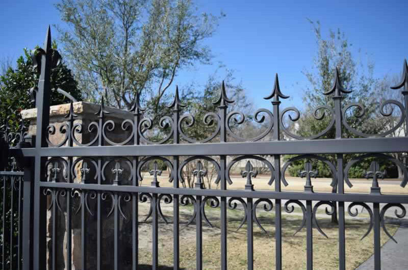 Residential black metal fence with decorative trim