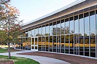 Glass wall of exercise centers with tree and grass