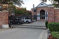 Brick wall with rolling gate and parking lot