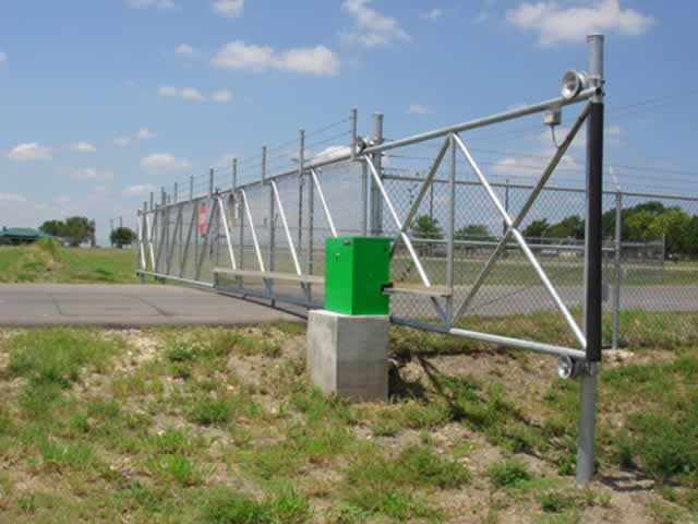 Gate operator with light brown wooden fence and rolling gate